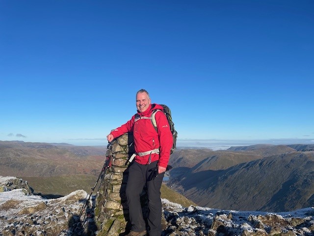 Peter Worsdworth, Director of Consumer Duty Services on top of hike summit